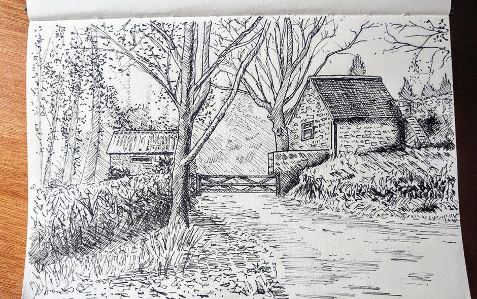 sketchbook showing a pen sketch of a sussex country house